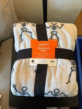 Holiday Home Microplush Throw Blanket in White with Black Skeleton Print